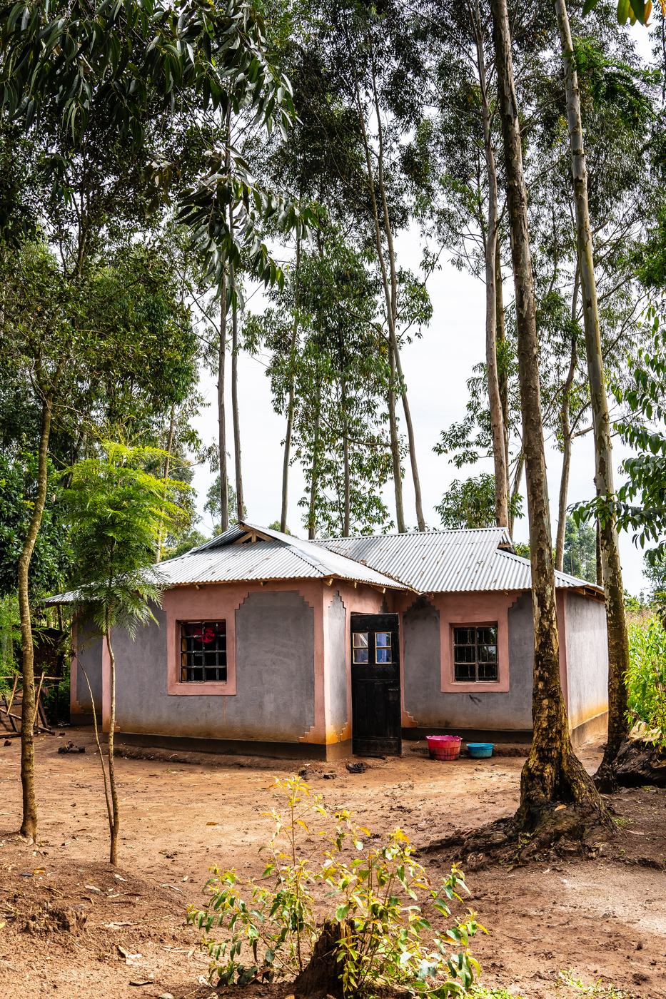 A newly built earthen home with a coral-trimmed finish